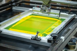 Production methods screen print. A silkscreen print station during the overlay stage of