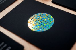 Closeup of the printed round hologram badge of the Cyriano Dogwear Outfit Certificate of Authenticity card. Branding & Identity.