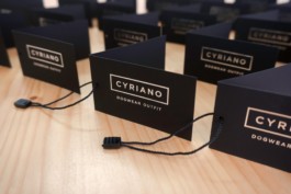 Closeup of Cyriano Dogwear Outfit clothes labels over wooden table. Branding & Identity.