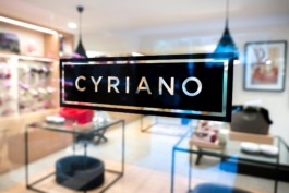 Closeup of the logo on the glass door of the Cyriano Dogwear Outfit shop entrance. Photography, Branding & Identity.