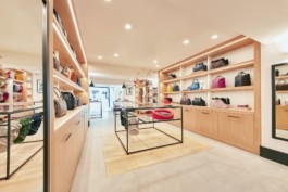 General back view of the Cyriano Dogwear Outfit flagship store with display units, shelves full of clothes and accessories. Photography, Branding & Identity.