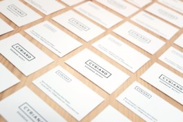 Cyriano Dogwear Outfit business cards over wooden table. Seamless perspective photo. Branding & Identity.
