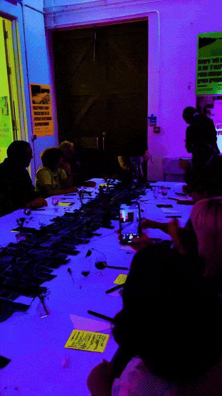 SPG Curated Dinner Short Video Clip of the event. The video shows the table setting with the audience. The hosts are filling clear water using a 3D printed filter by Thomas Pausz. The audience looks interested and some of them are recording the moment with their mobile phones.
