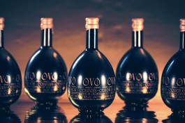 OVO dark bottles front view. Five bottles over a gold background. Dark atmosphere.